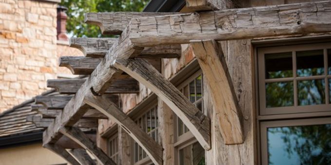 Reclaimed hand-hewn white oak timber trusses, purlins, rafters and beams bring historic character and life to every angle of the exterior.